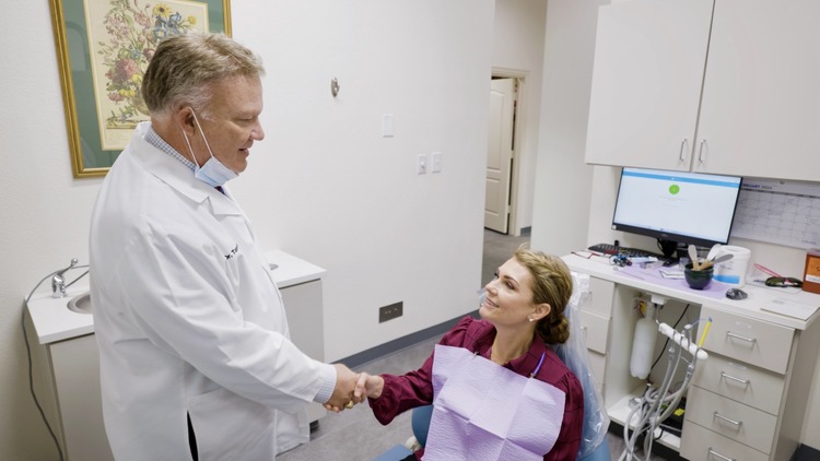 Doctor Thomas Nabors, a dentist in Las Colinas, shaking hands with a patient